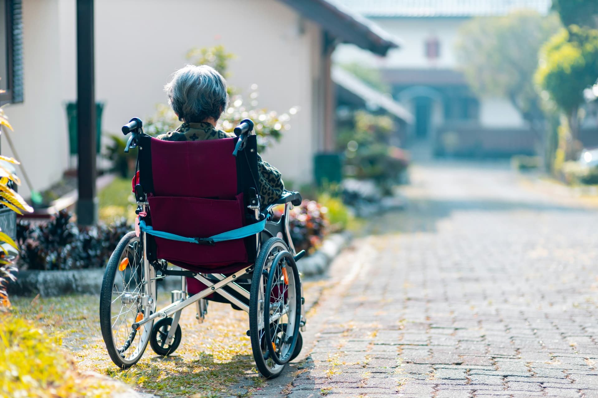 Woman sitting on wheelchair outdoors